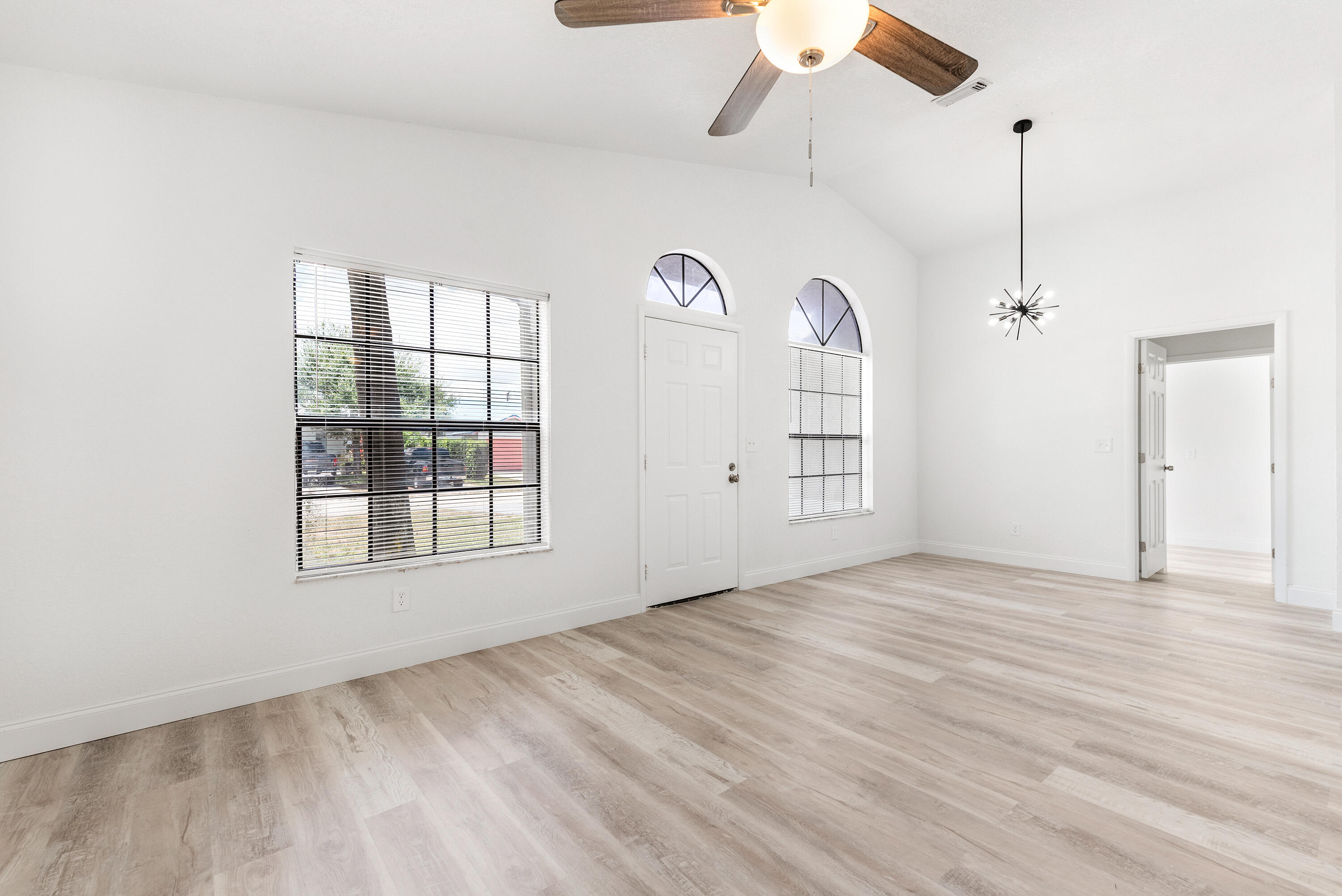 5629 Southeast Collins Avenue Stuart, FL 34997 - Photo 8 of 39 a view of empty room with windows