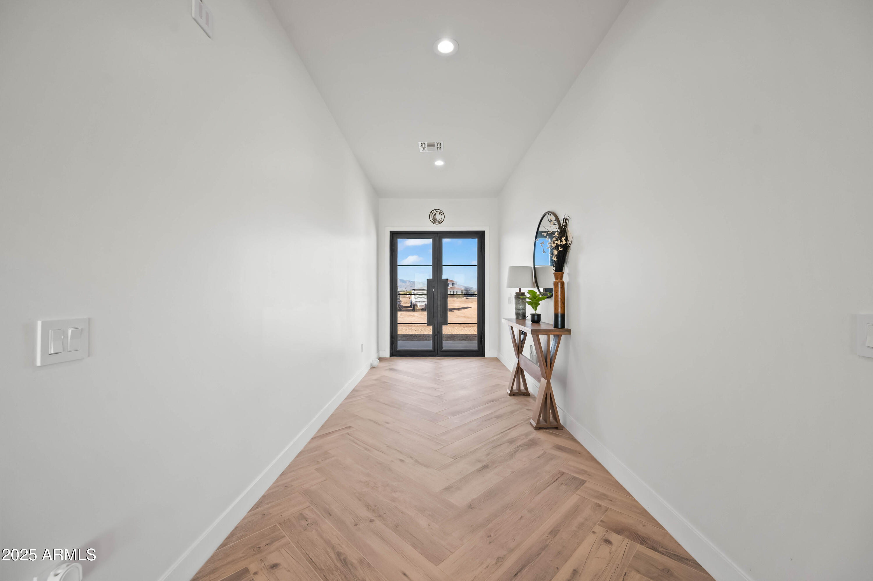 22145 West Harwell Road Buckeye, AZ 85326 - Photo 11 of 86 a view of a hallway with wooden floor and entryway