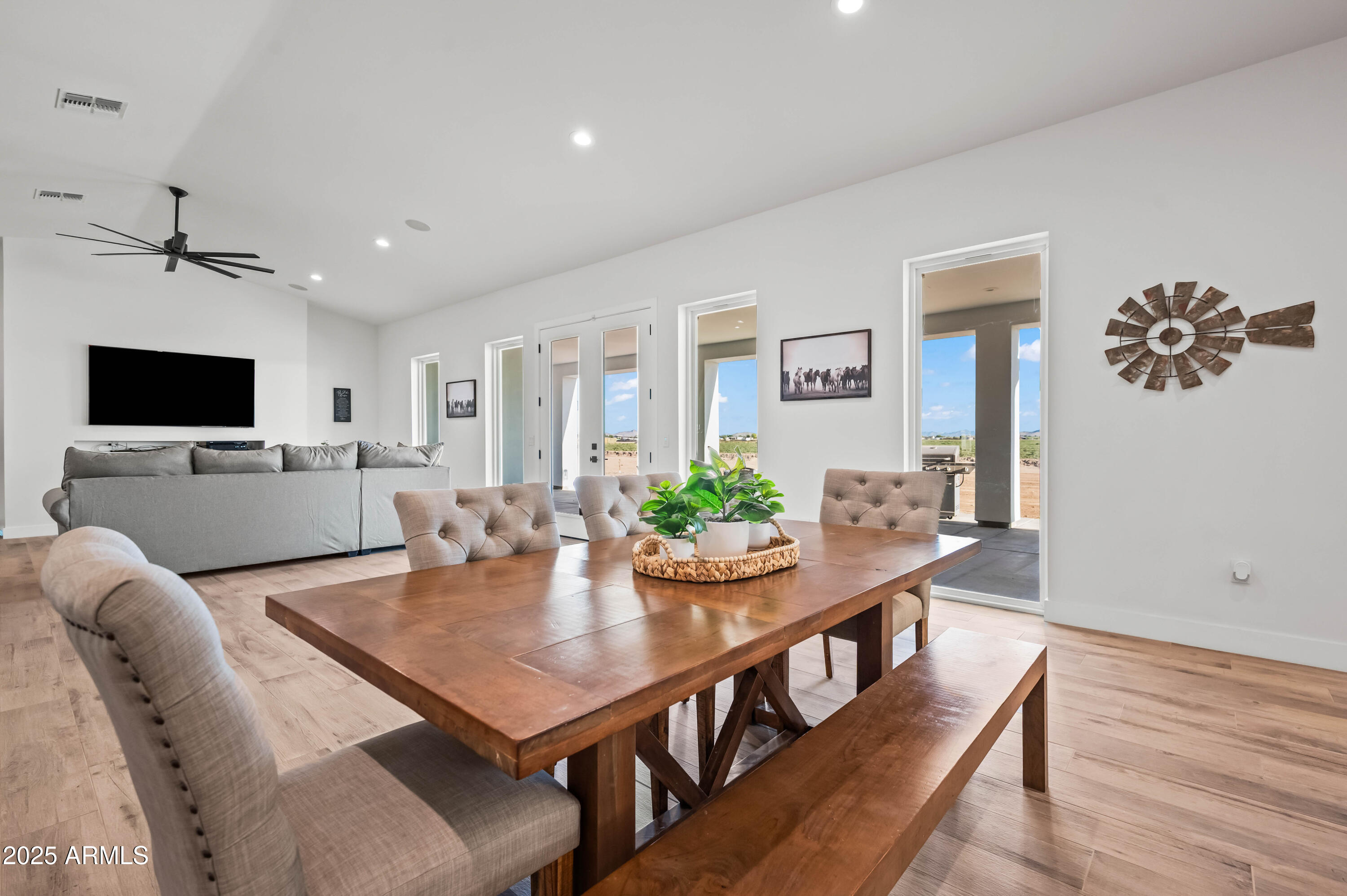 22145 West Harwell Road Buckeye, AZ 85326 - Photo 14 of 86 a view of a dining room with furniture and wooden floor