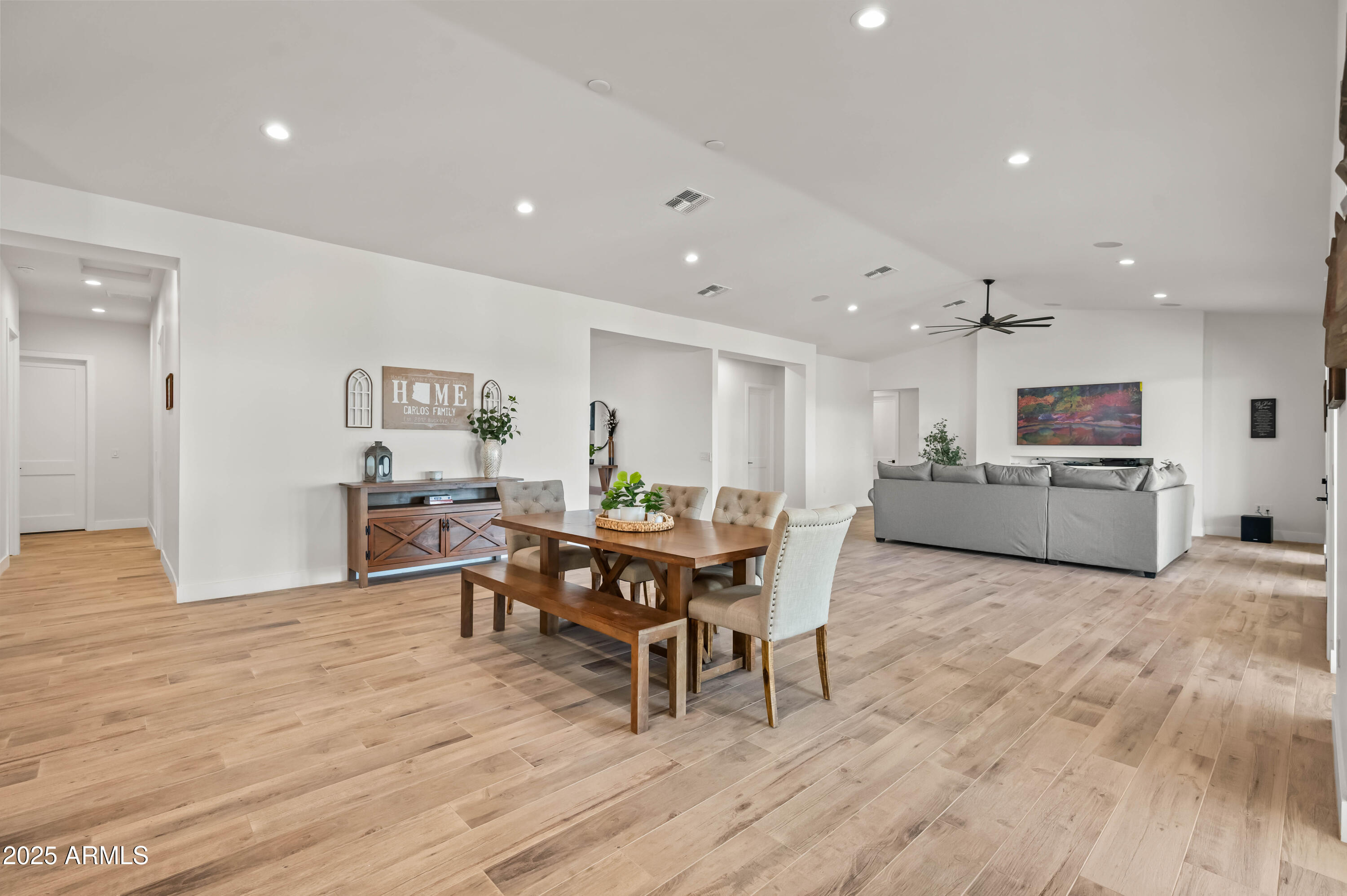 22145 West Harwell Road Buckeye, AZ 85326 - Photo 15 of 86 a view of a dining room with furniture and wooden floor