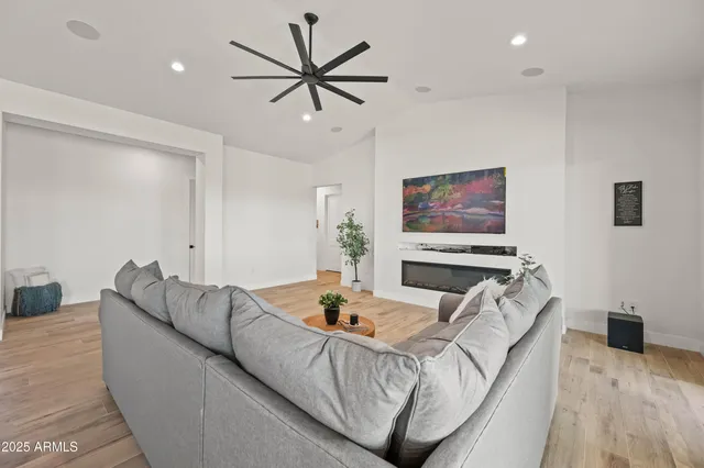 a living room with furniture a dining table and a potted plant
