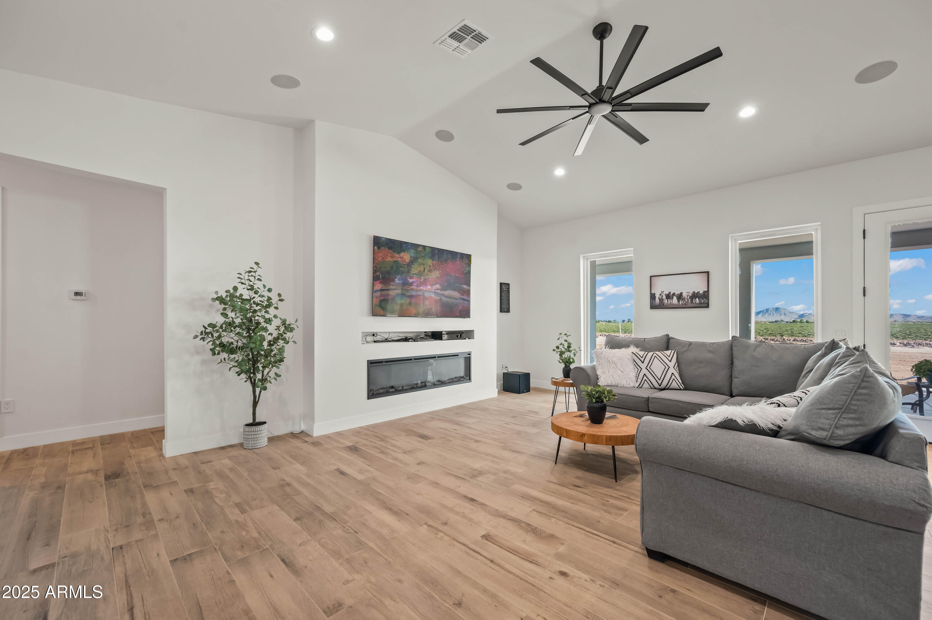22145 West Harwell Road Buckeye, AZ 85326 - Photo 19 of 86 a living room with furniture and a large window with wooden floor