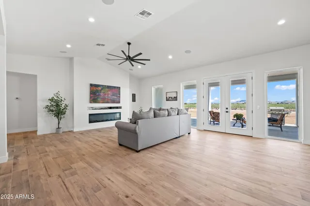 a kitchen with stainless steel appliances granite countertop a sink a stove and a wooden floors