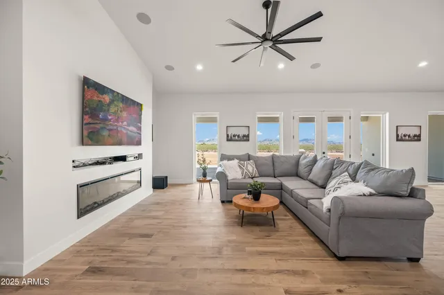 a kitchen with stainless steel appliances kitchen island granite countertop a dining table chairs and white cabinets
