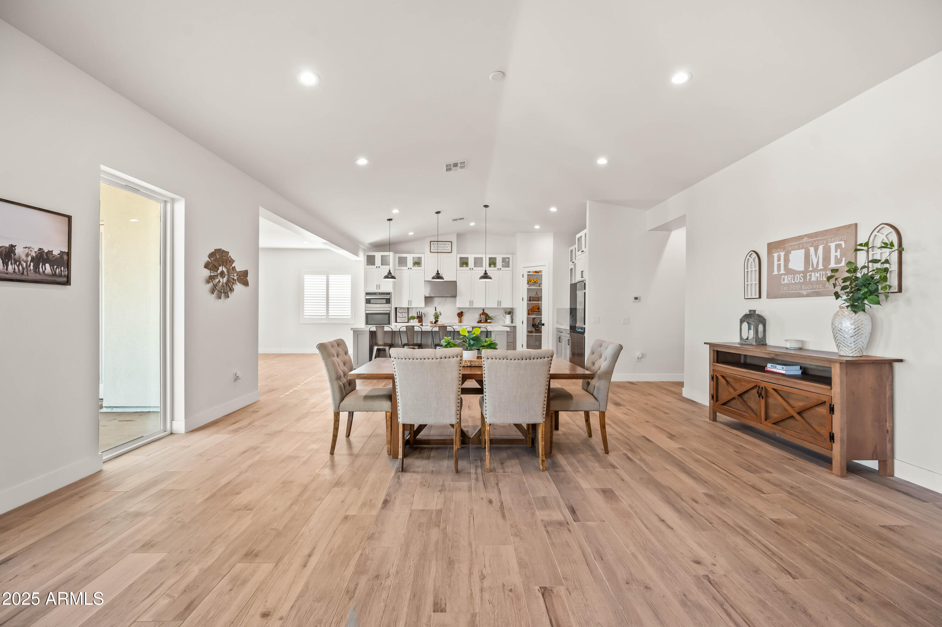 22145 West Harwell Road Buckeye, AZ 85326 - Photo 27 of 86 a view of a dining room with furniture and wooden floor