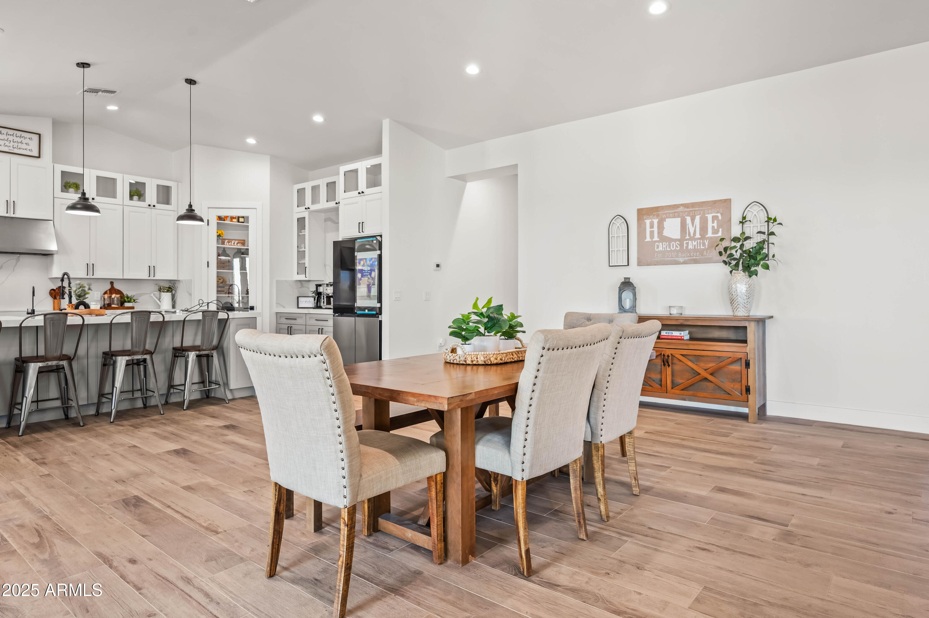 22145 West Harwell Road Buckeye, AZ 85326 - Photo 28 of 86 a view of a dining room with furniture and wooden floor