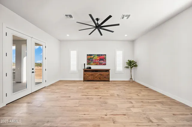 a bathroom with a toilet a sink a mirror and vanity