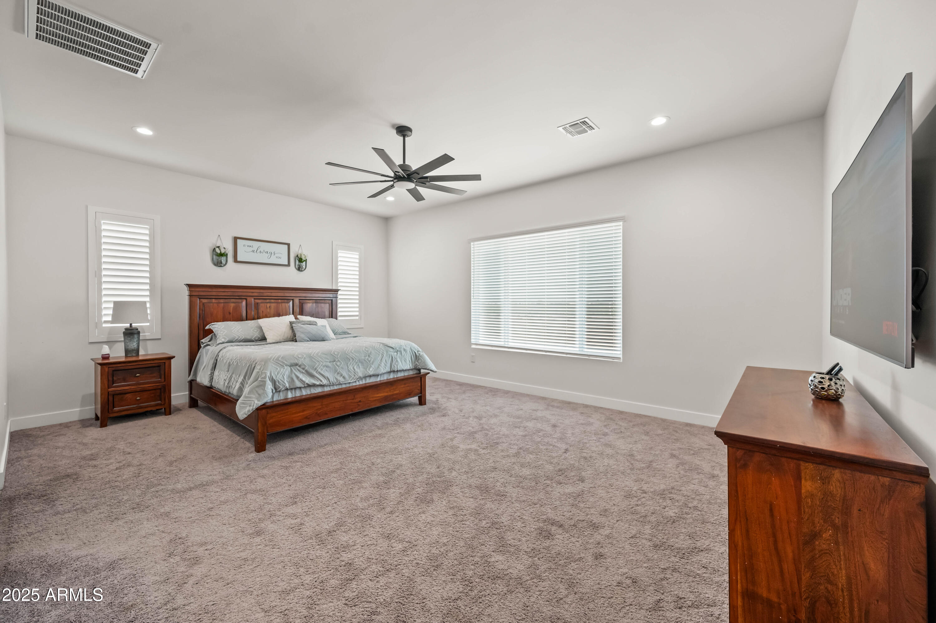 22145 West Harwell Road Buckeye, AZ 85326 - Photo 44 of 86 a bedroom with a bed and a flat screen tv