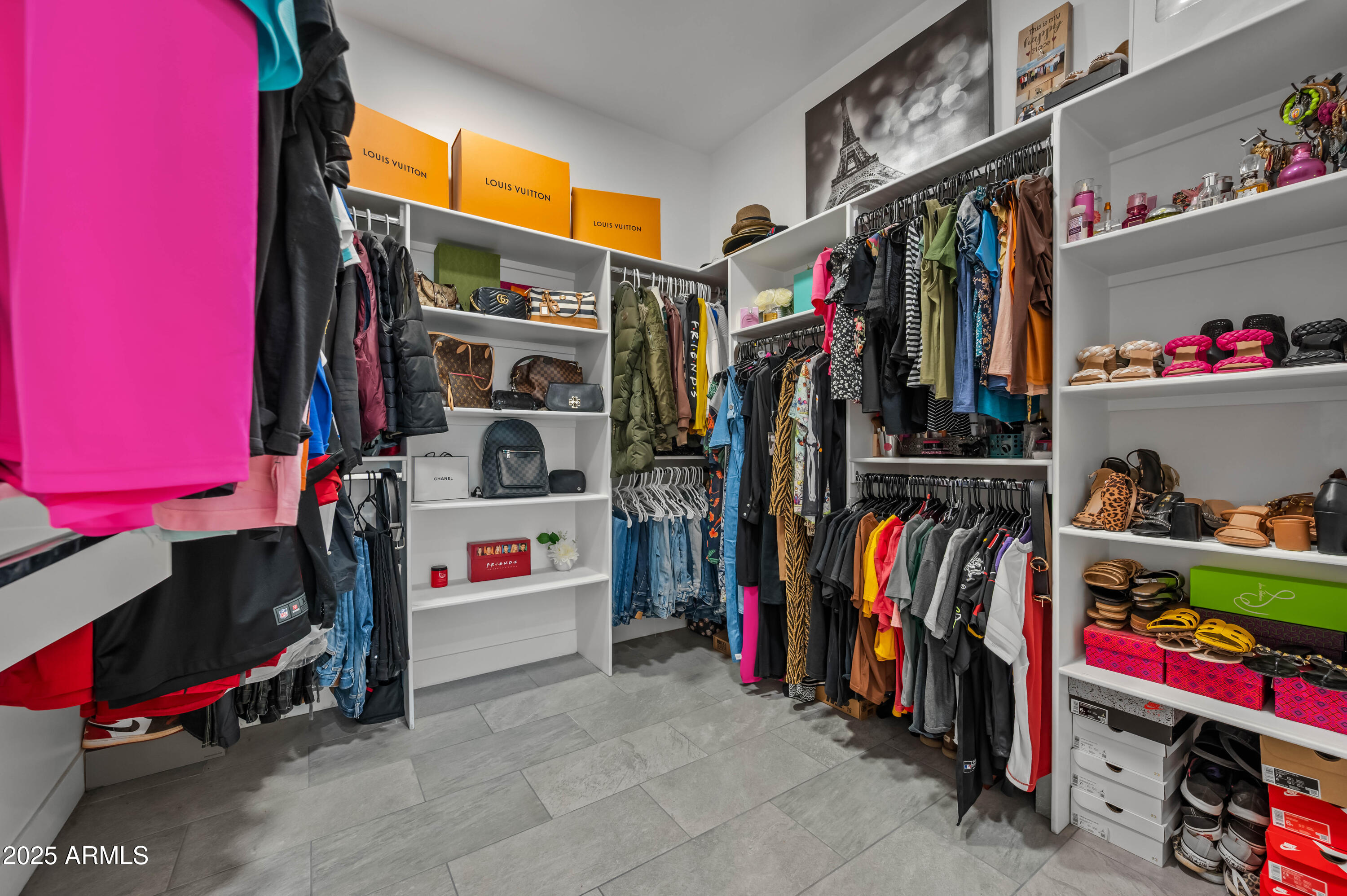22145 West Harwell Road Buckeye, AZ 85326 - Photo 55 of 86 a view of walk in closet with clothes and shoes