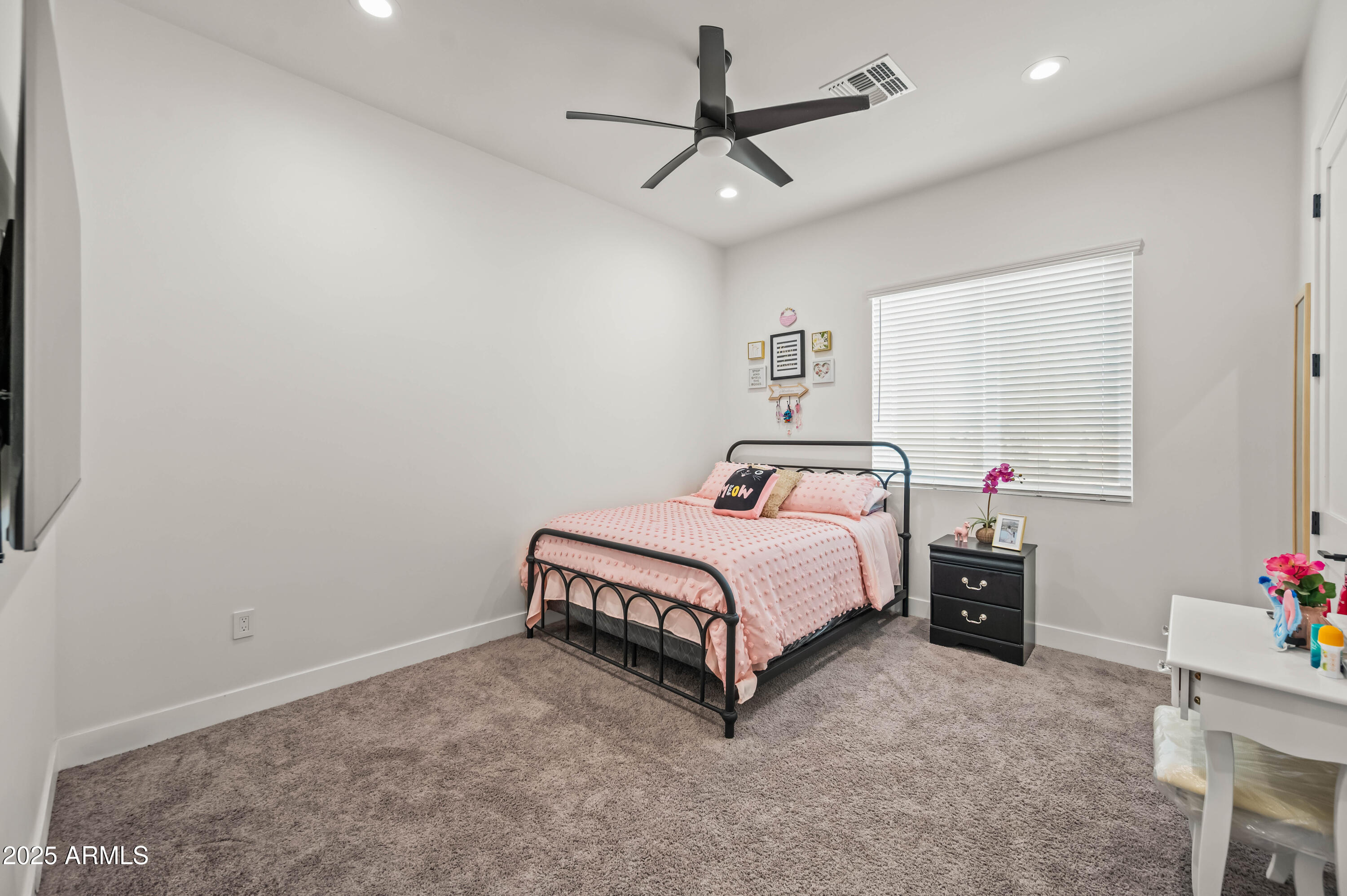22145 West Harwell Road Buckeye, AZ 85326 - Photo 58 of 86 a bedroom with a bed and a chandelier