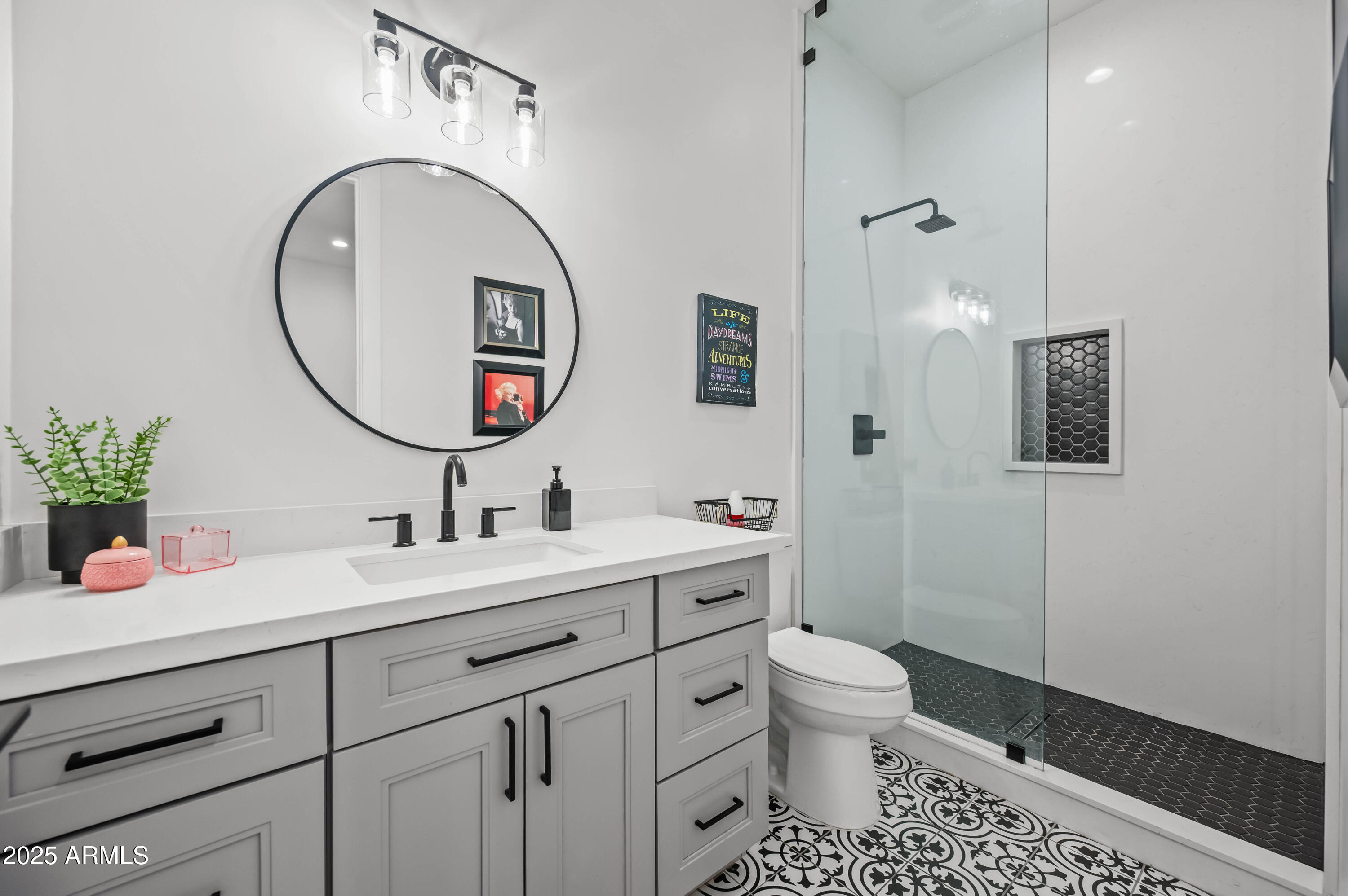 22145 West Harwell Road Buckeye, AZ 85326 - Photo 59 of 86 a bathroom with a toilet a sink a mirror and vanity