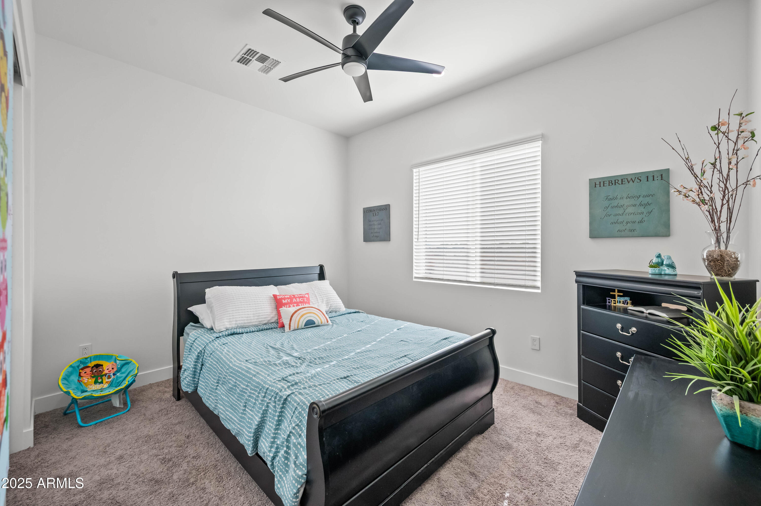 22145 West Harwell Road Buckeye, AZ 85326 - Photo 65 of 86 a bedroom with a bed a dresser and a potted plant
