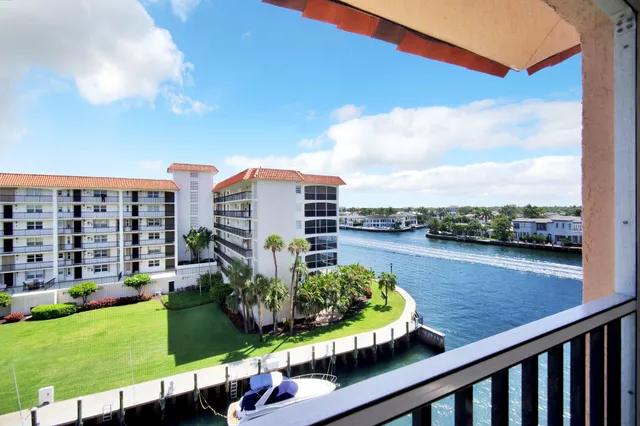 a kitchen with stainless steel appliances kitchen island granite countertop a stove a refrigerator and a microwave oven with a dining table