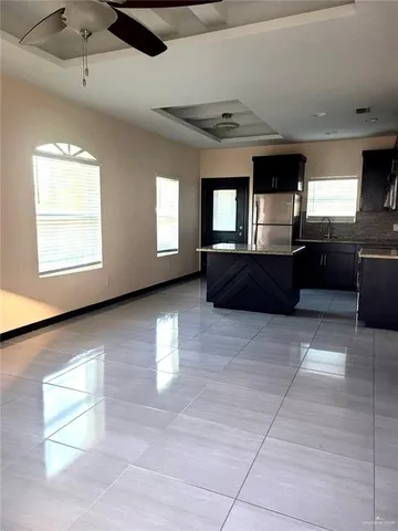 a view of a kitchen with furniture and windows