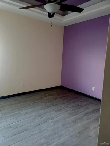 a view of a room with wooden floor