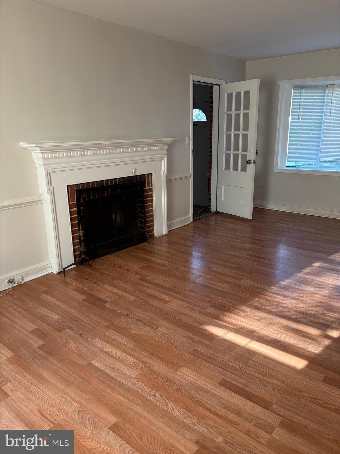 8028 Eastern Avenue Northwest Washington, DC 20012 - Photo 25 of 54 a view of an empty room with wooden floor fireplace and a window