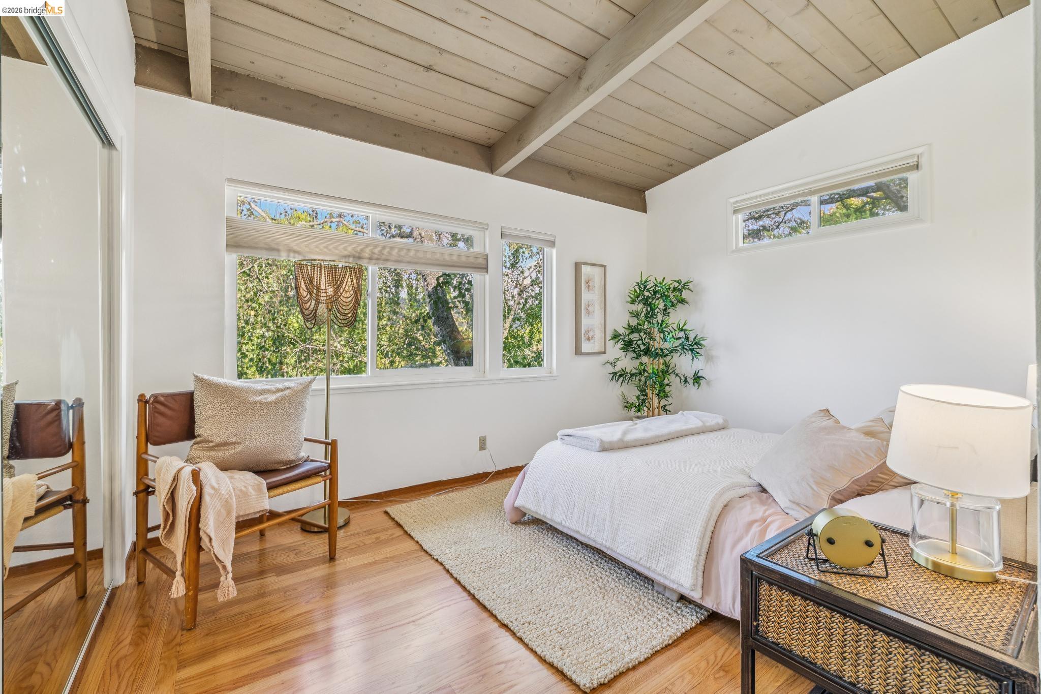 1024 Overlook Road Berkeley, CA 94708 - Photo 29 of 41 Hardwood flooring, vaulted wood-paneled ceiling, large windows, transom window, and mirrored closet doors