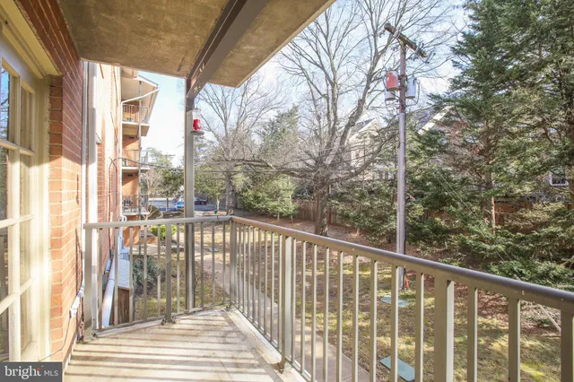 a view of a balcony with wooden floor and fence