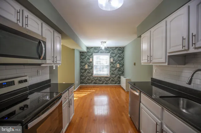 a kitchen with a stove and a microwave