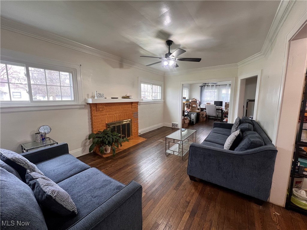 1686 Avalon Road Cleveland, OH 44112 - Photo 7 of 22 Living area with crown molding, a ceiling fan, a fireplace, and hardwood / wood-style floors