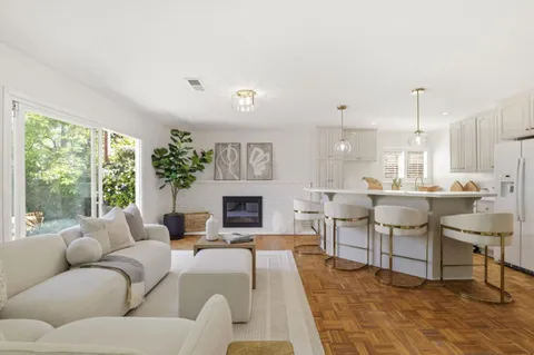 a living room with furniture a fireplace and a table