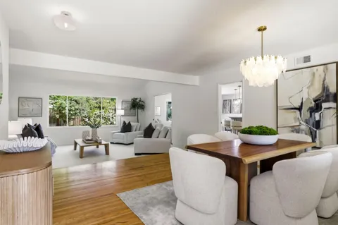 a living room with fireplace furniture and a chandelier