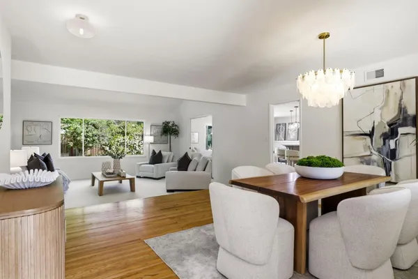 a living room with fireplace furniture and a chandelier