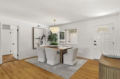 a living room with a couch and chandelier