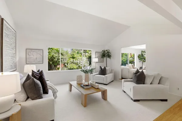 a living room with furniture and kitchen view