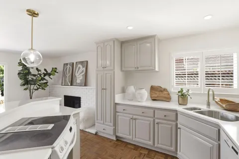a kitchen with a sink cabinets and window