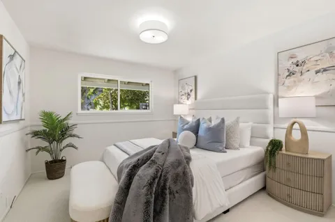 a bedroom with bed and windows