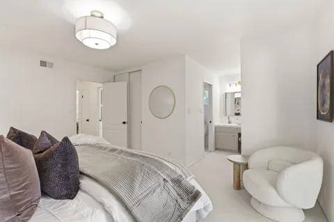 a bedroom with a bed and chandelier