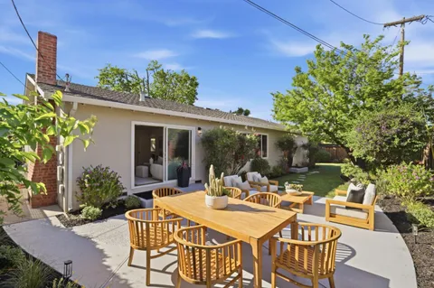 a view of a patio with table and chairs and potted plants