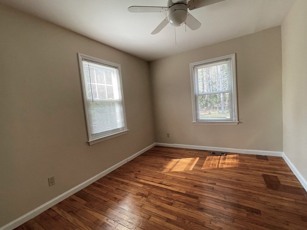 20 Howell Road Sudbury, MA 01776 - Photo 16 of 39 a view of an empty room with wooden floor and a window