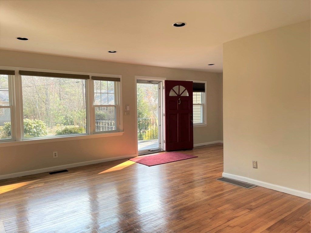20 Howell Road Sudbury, MA 01776 - Photo 3 of 39 a view of an empty room with wooden floor and a window