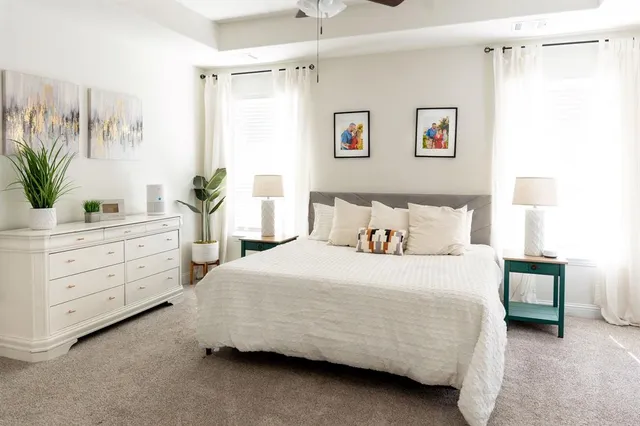a room with a table chairs and a kitchen view