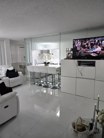 a living room with furniture and a kitchen area
