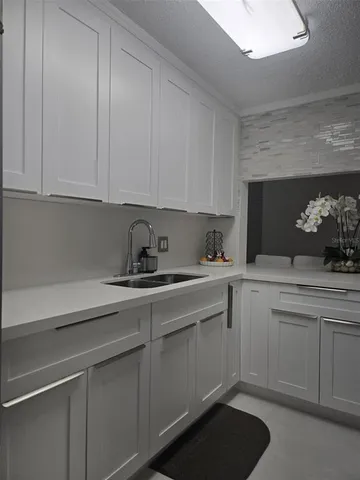 a kitchen with a sink and cabinets