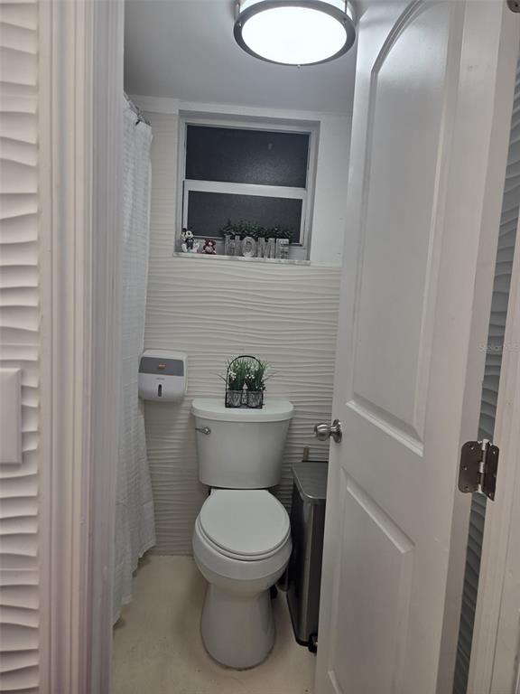 9410 Live Oak Place, Unit 103 Davie, FL 33324 - Photo 13 of 49 a white toilet sitting next to a bathroom sink