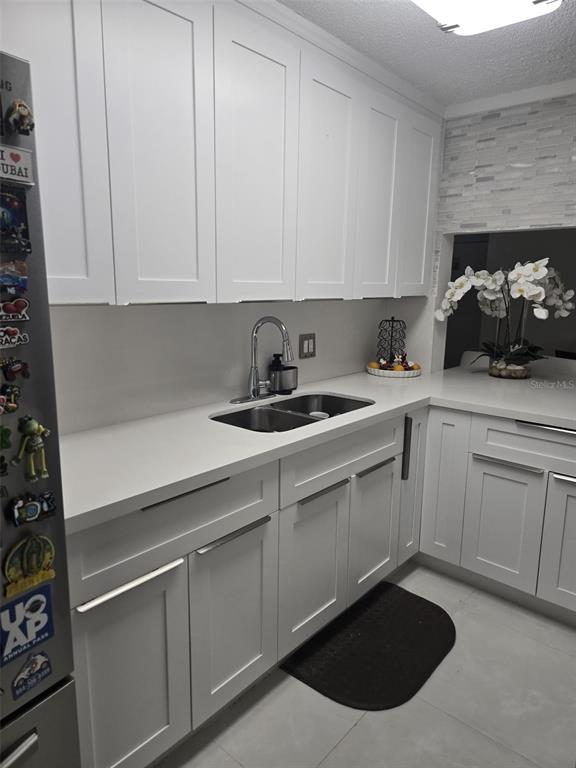 9410 Live Oak Place, Unit 103 Davie, FL 33324 - Photo 14 of 49 a kitchen with stainless steel appliances granite countertop a sink dishwasher a stove and white cabinets