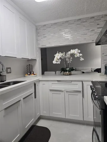 a kitchen with a sink cabinets and appliances