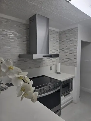 a kitchen with granite countertop a stove and a sink