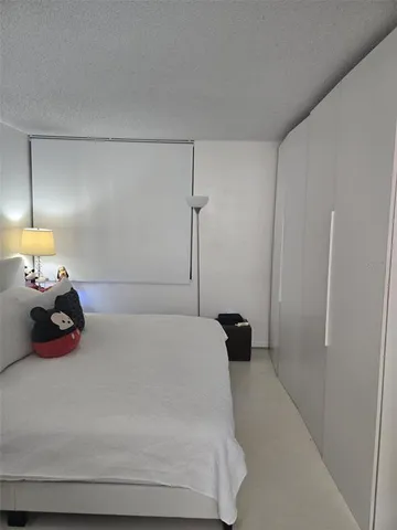 a bedroom with a bed and a lamp