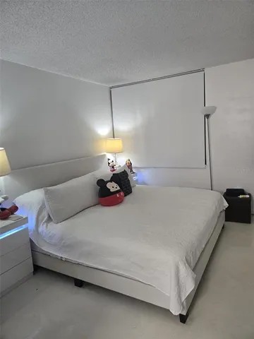 a bed room with a bed and a night stand