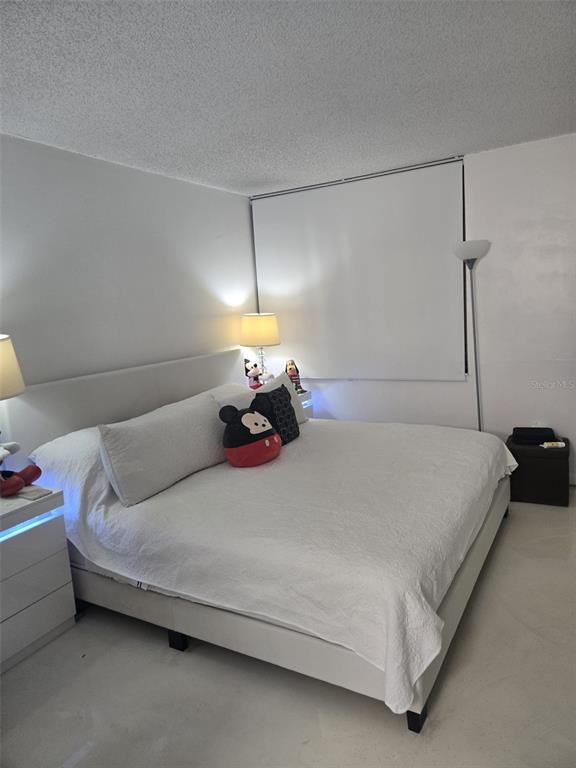 9410 Live Oak Place, Unit 103 Davie, FL 33324 - Photo 19 of 49 a bed room with a bed and a night stand