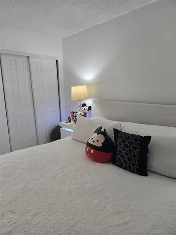 a bedroom with a bed and cabinets