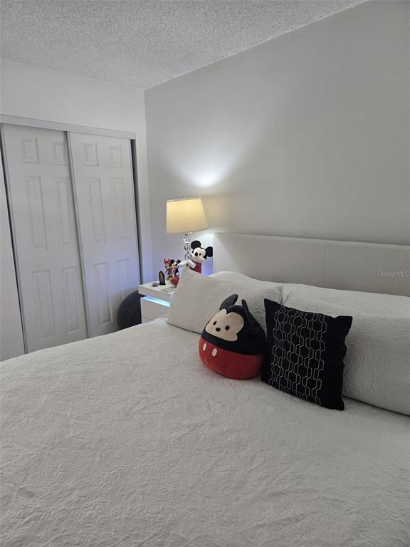 9410 Live Oak Place, Unit 103 Davie, FL 33324 - Photo 20 of 49 a bedroom with a bed and cabinets