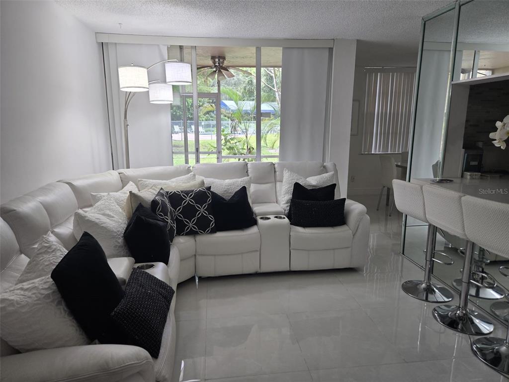 9410 Live Oak Place, Unit 103 Davie, FL 33324 - Photo 2 of 49 a living room with furniture and a large window