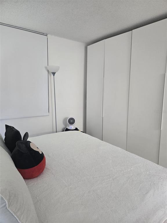 9410 Live Oak Place, Unit 103 Davie, FL 33324 - Photo 21 of 49 a bedroom with a bed and a dresser