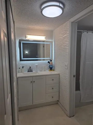 a kitchen with sink and mirror